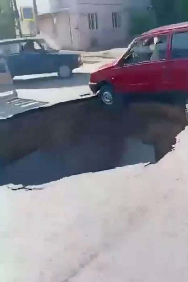 Clueless Motorist Left Teetering On The Edge As He Completely Ignores Massive Sinkhole